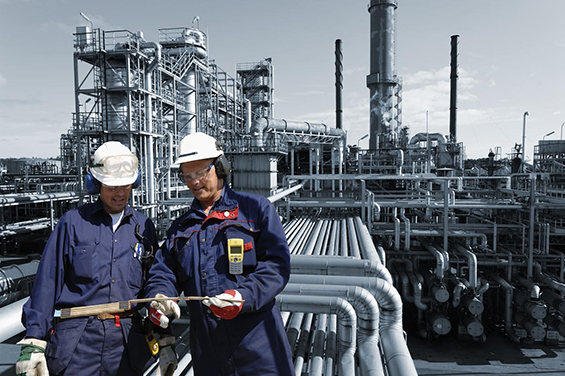 refinery workers inside oil and gas installation